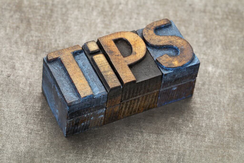 tips word - text in vintage letterpress wood type blocks against a grunge metal background