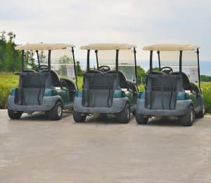 golf carts in driveway with titles