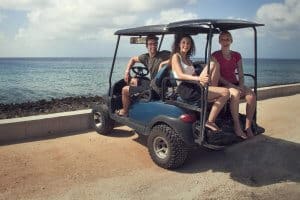 tourists riding golf cart