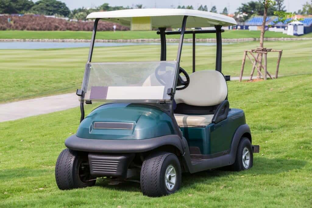 golf cart parked in the grass