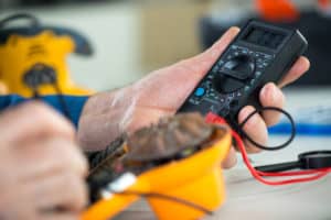 worker holding voltmeter