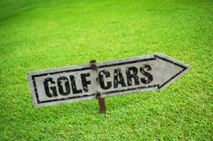 rusty golf cart sign says golf cars up hill