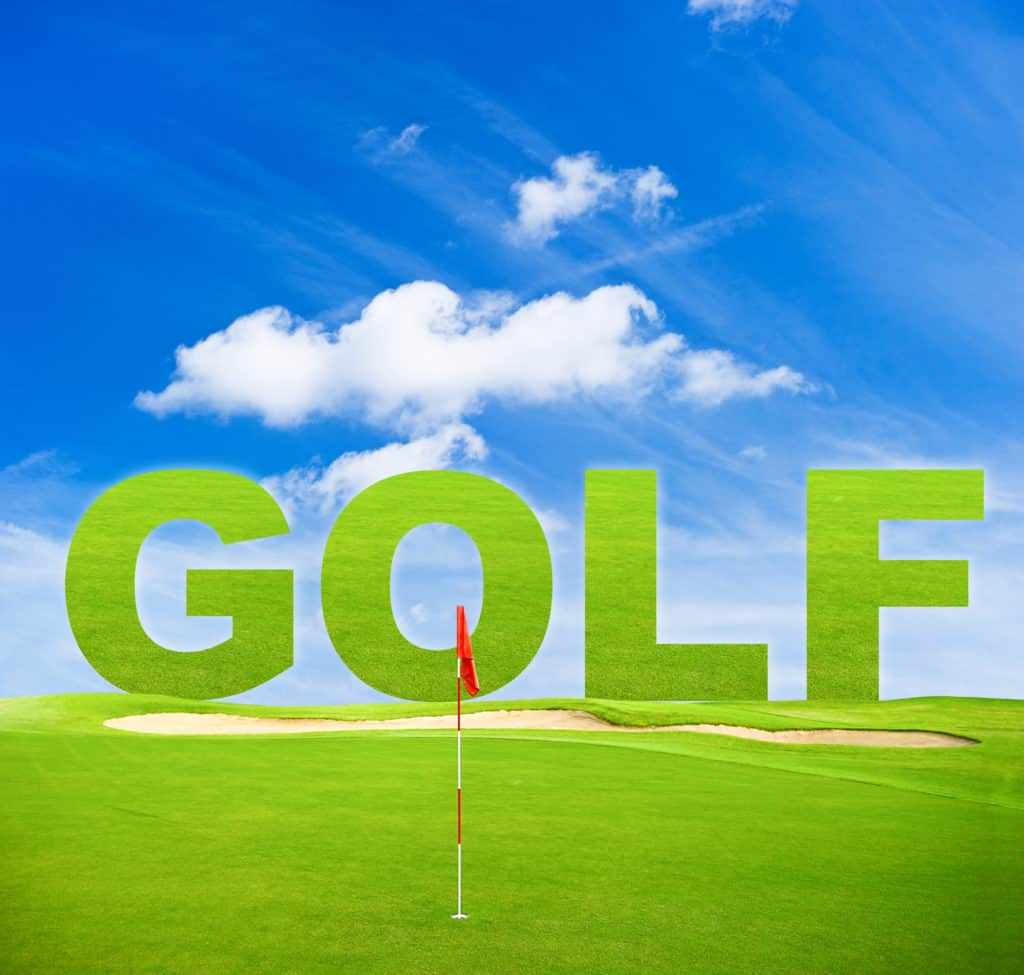 green golf field with red flag and blue sky background