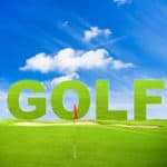 green golf field with red flag and blue sky background