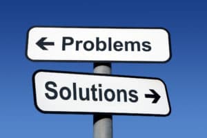 Sign post pointing to problems and solutions.