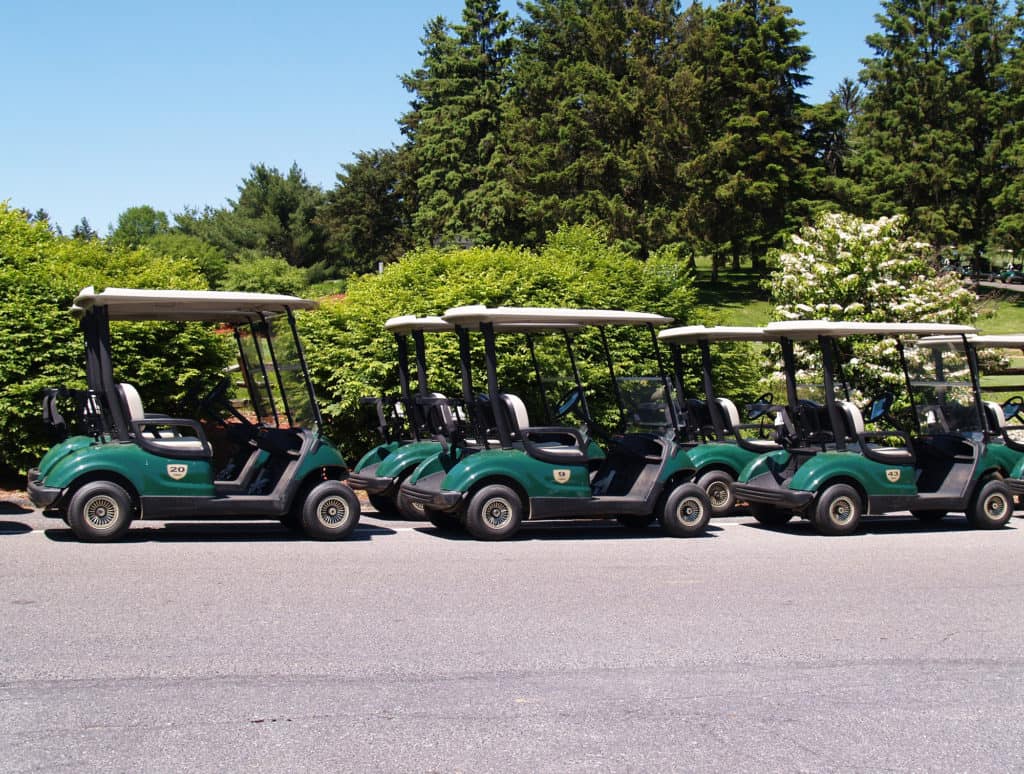 a row of empty golf carts ready for use