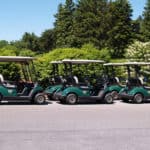 a row of empty golf carts ready for use