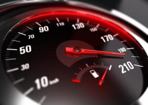 Close up of a car speedometer with the needle pointing a high speed, blur effect, conceptual image for excessive speeding or careless driving concept