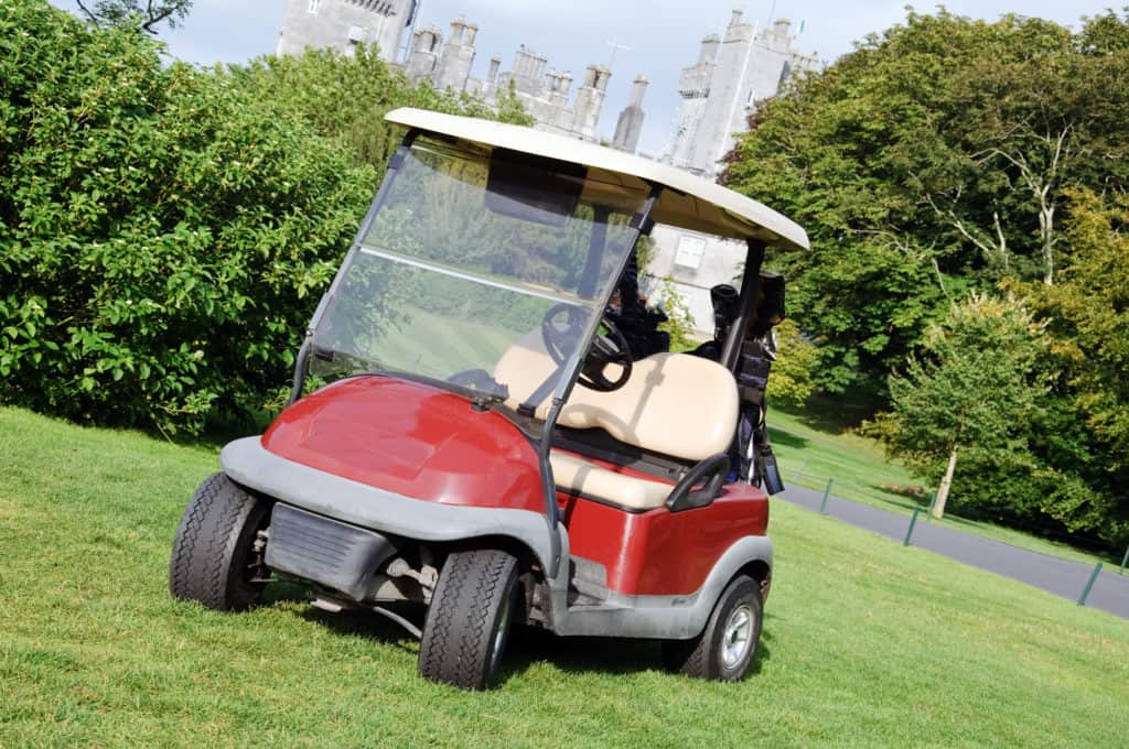 golf cart on luxury golf course by castle