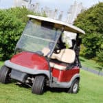 golf cart on luxury golf course by castle