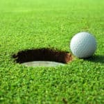 Golf ball near putting hole