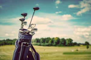 golf clubs on green golf course