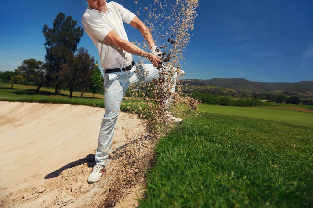 golf shot from sand bunker golfer hitting ball from hazard