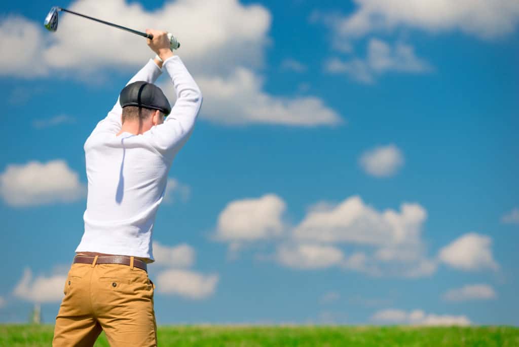 an evil aggressive golfer breaks his golf club after losing the