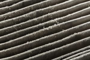 Close up dirty car air conditioner filter isolated on white - deep focus image