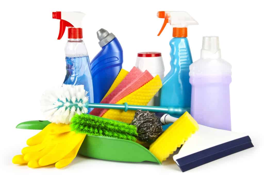 Collection of cleaning products and tools on white background