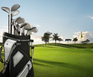 golf equipment on green and hole as background