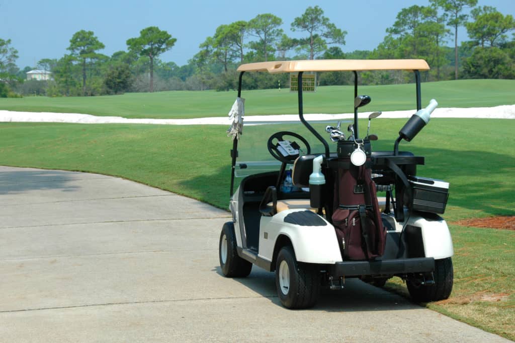 Golf cart on path of golf course