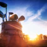 Professional golf gear on the golf field at sunset.