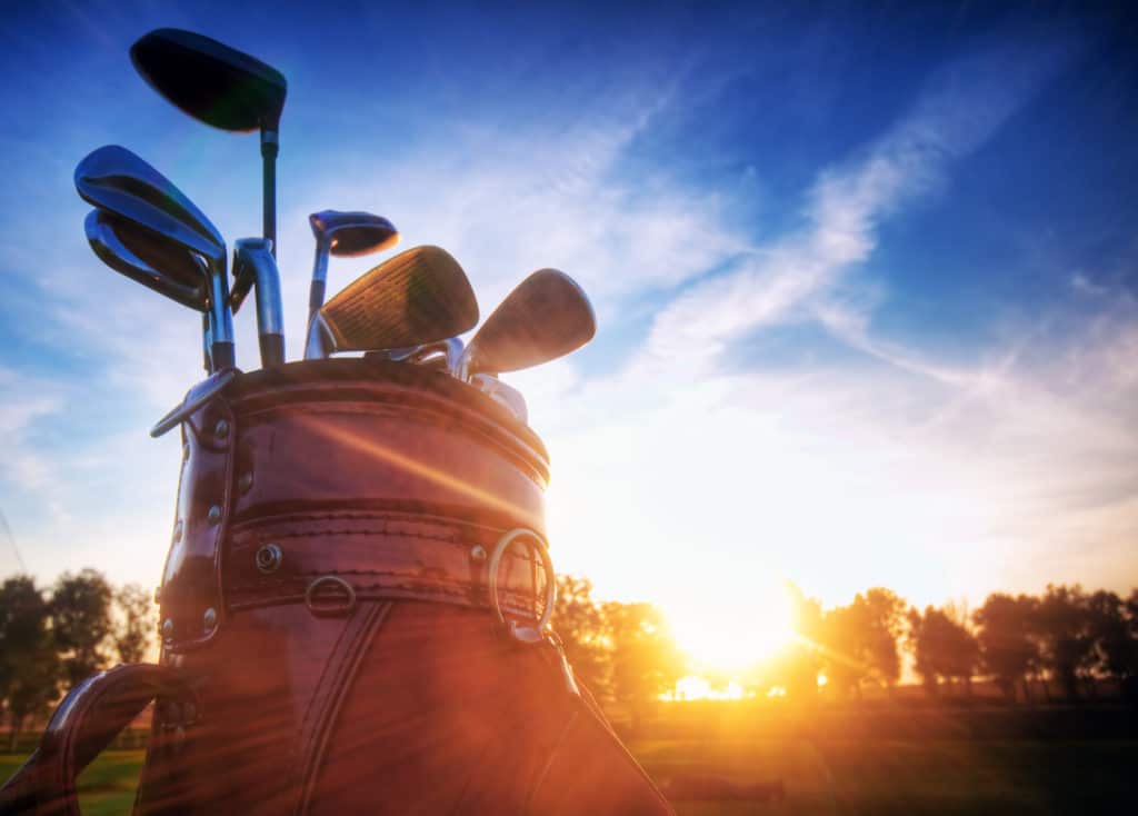 Professional golf gear on the golf field at sunset.