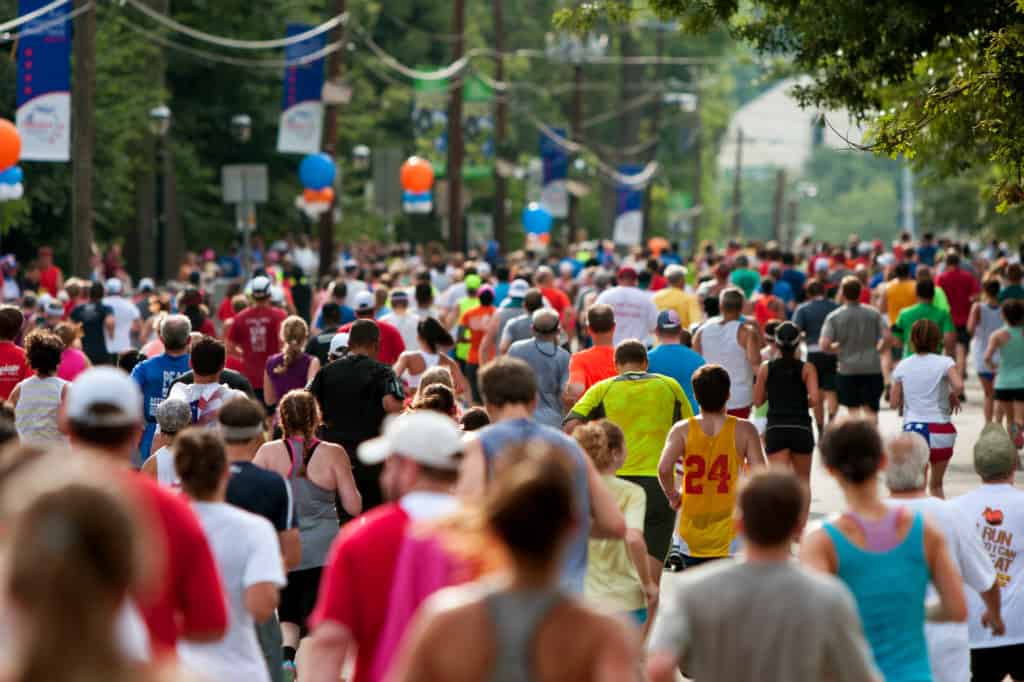 Atlanta, GA, USA - July 4, 2014: Thousands of runners crowd an Atlanta street on their way to the finish line of the Peachtree Road Race.