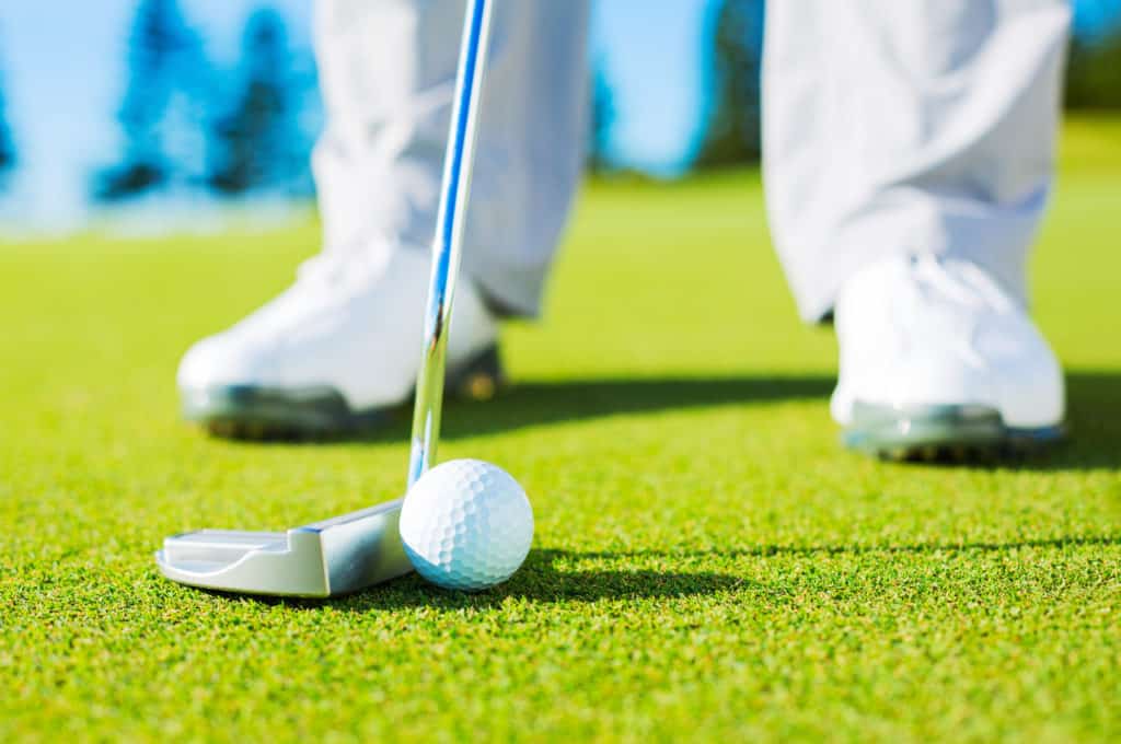 Man Putting Golf Ball into the Hole, Close up detail Shot