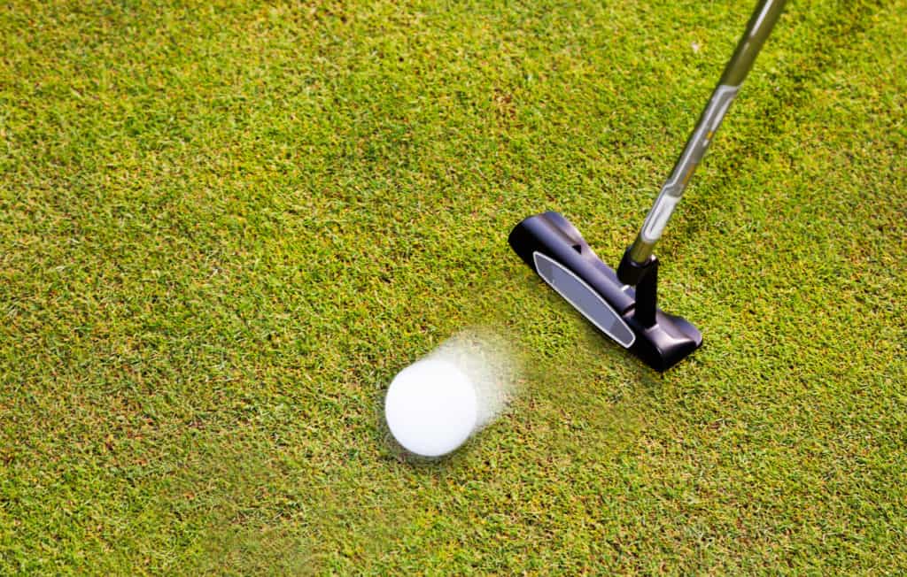 Golf: putter club with white golf ball