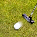 Golf: putter club with white golf ball