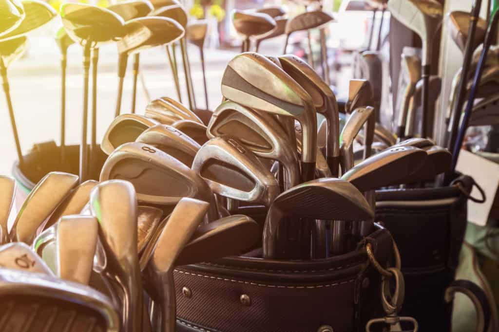 set of golf bags with clubs