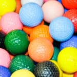 Close up of a pile of multi-colored golf balls