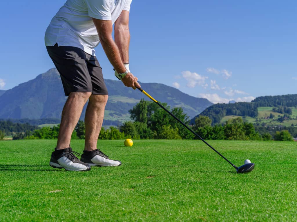 Golfer swinging driver