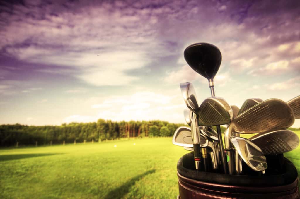 Professional golf gear on the golf field at sunset.