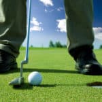 A golf put into the hole