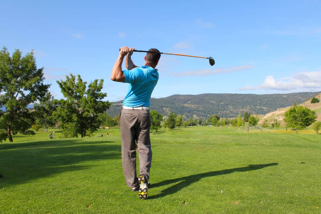 Young male golfer hitting a driver from the tee-box