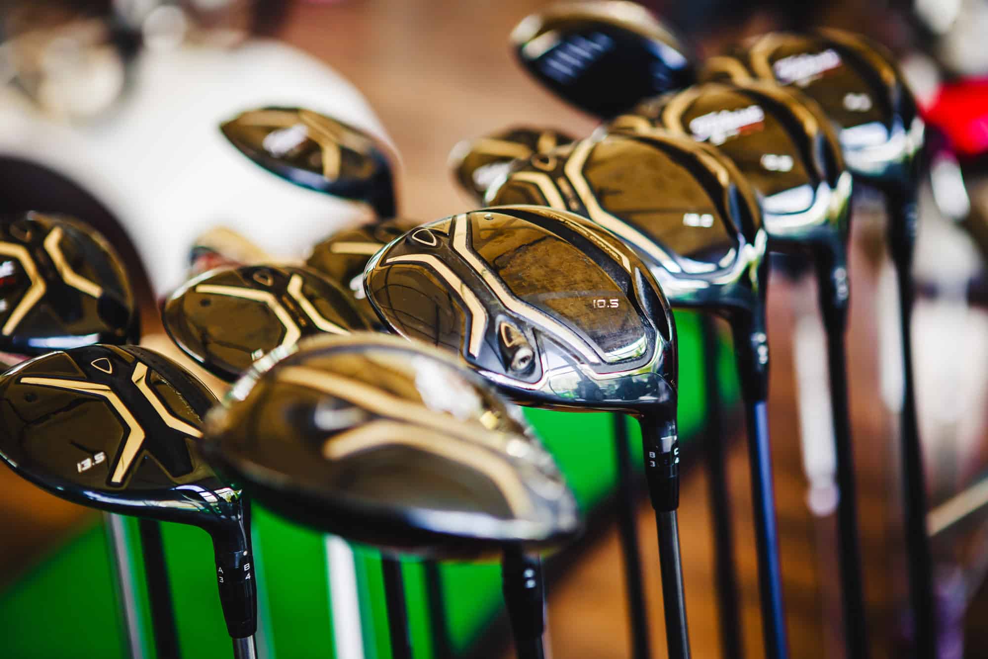 A shiny metal golf clubs for sale show in shop rack.