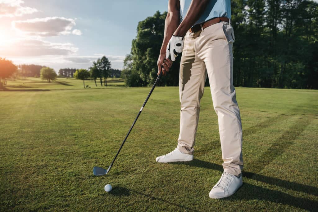 man lined up to hit golf ball