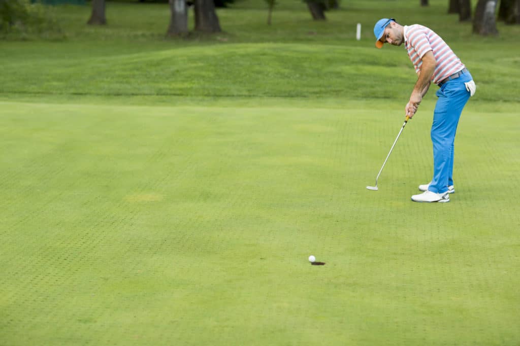 Young man playing golf