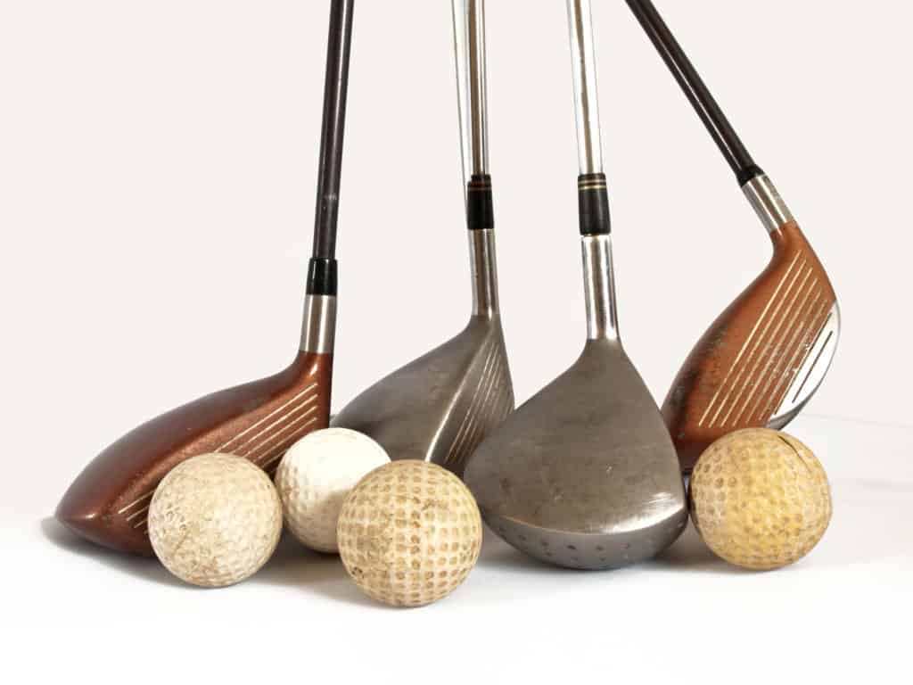 antique golf balls and old clubs