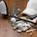 golf clubs with tees and hat