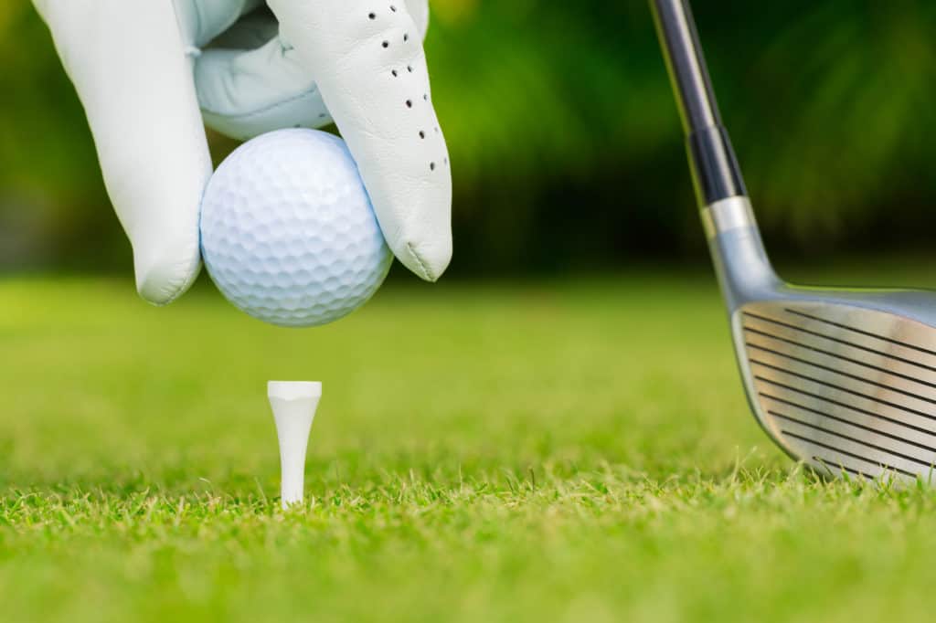 Close up view of golf ball on tee on golf course