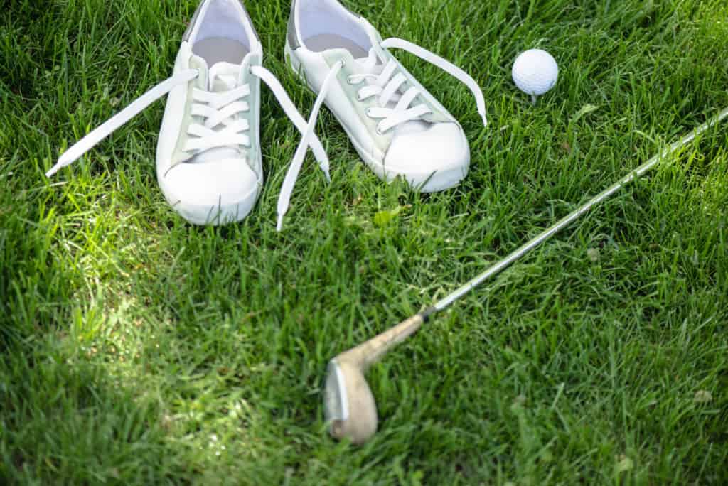 golf shoes lying in grass