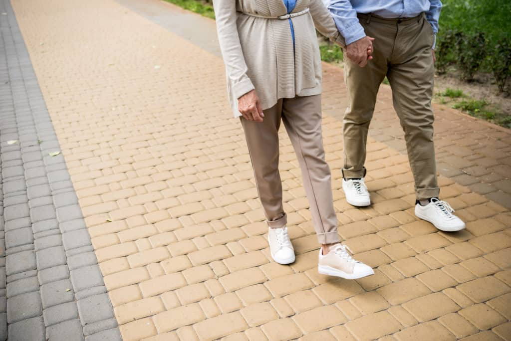 seniors walking on sidewalk in shoes