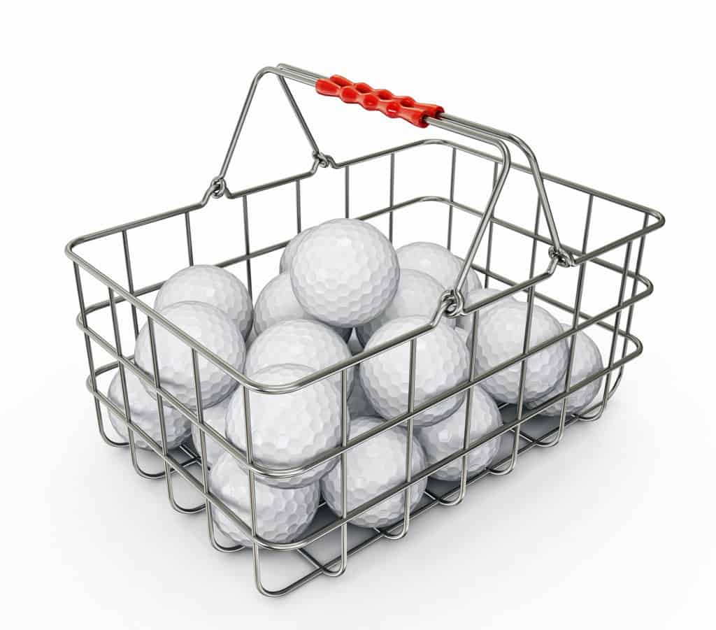 golf balls in basket isolated on a white