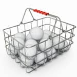 golf balls in basket isolated on a white