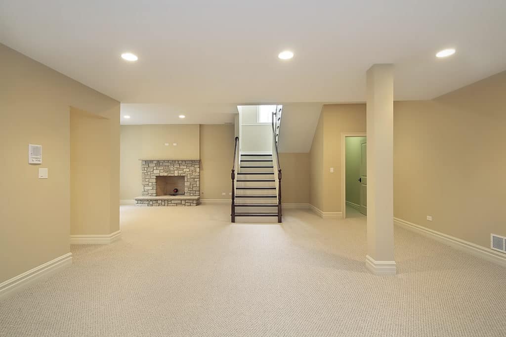 Basement in new construction home with stone fireplace