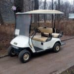 EZGO golf cart parked on side of road