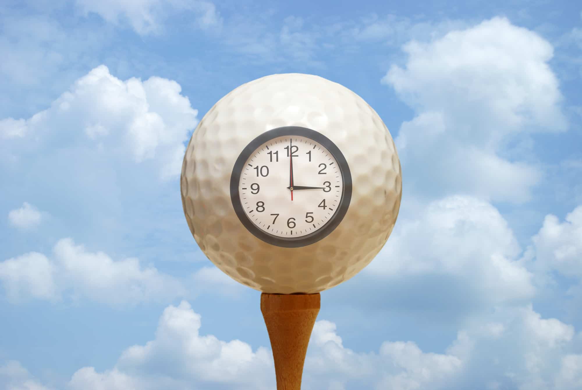 A golf ball and clock remind the golfer of their tee off.