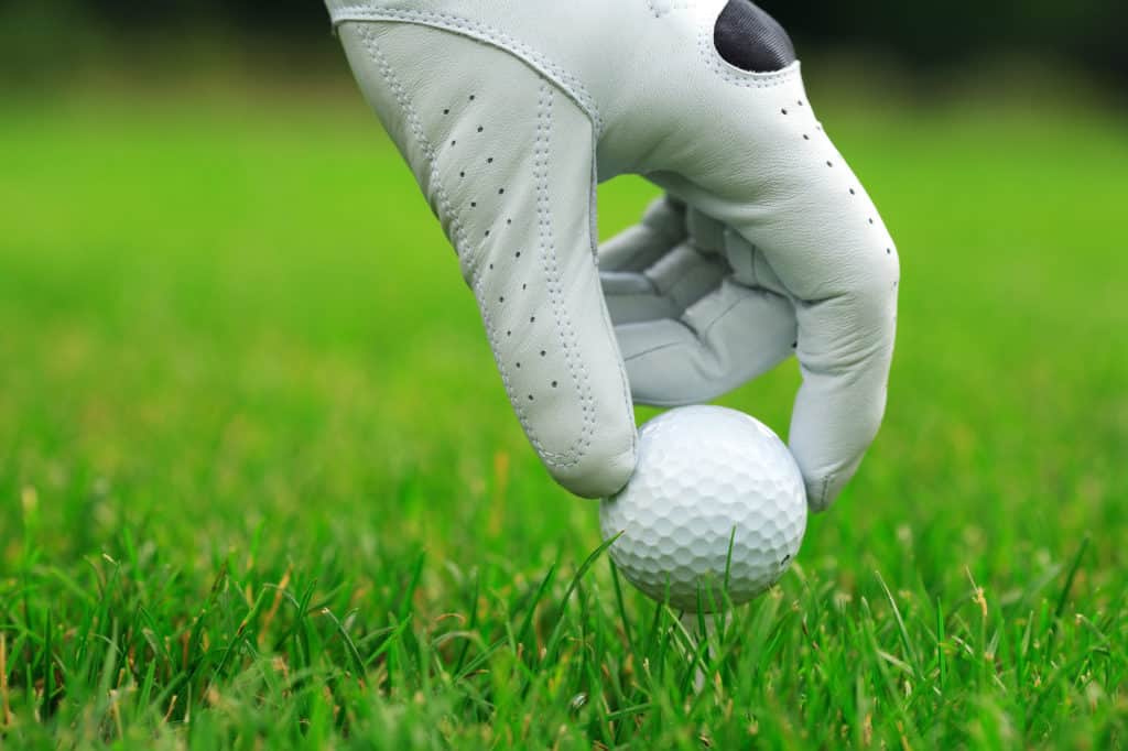 Detail of golf ball and gloves