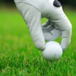 Detail of golf ball and gloves