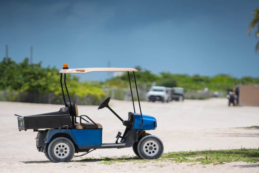 Photo of a golf cart on the beach shot with telephoto lens USA